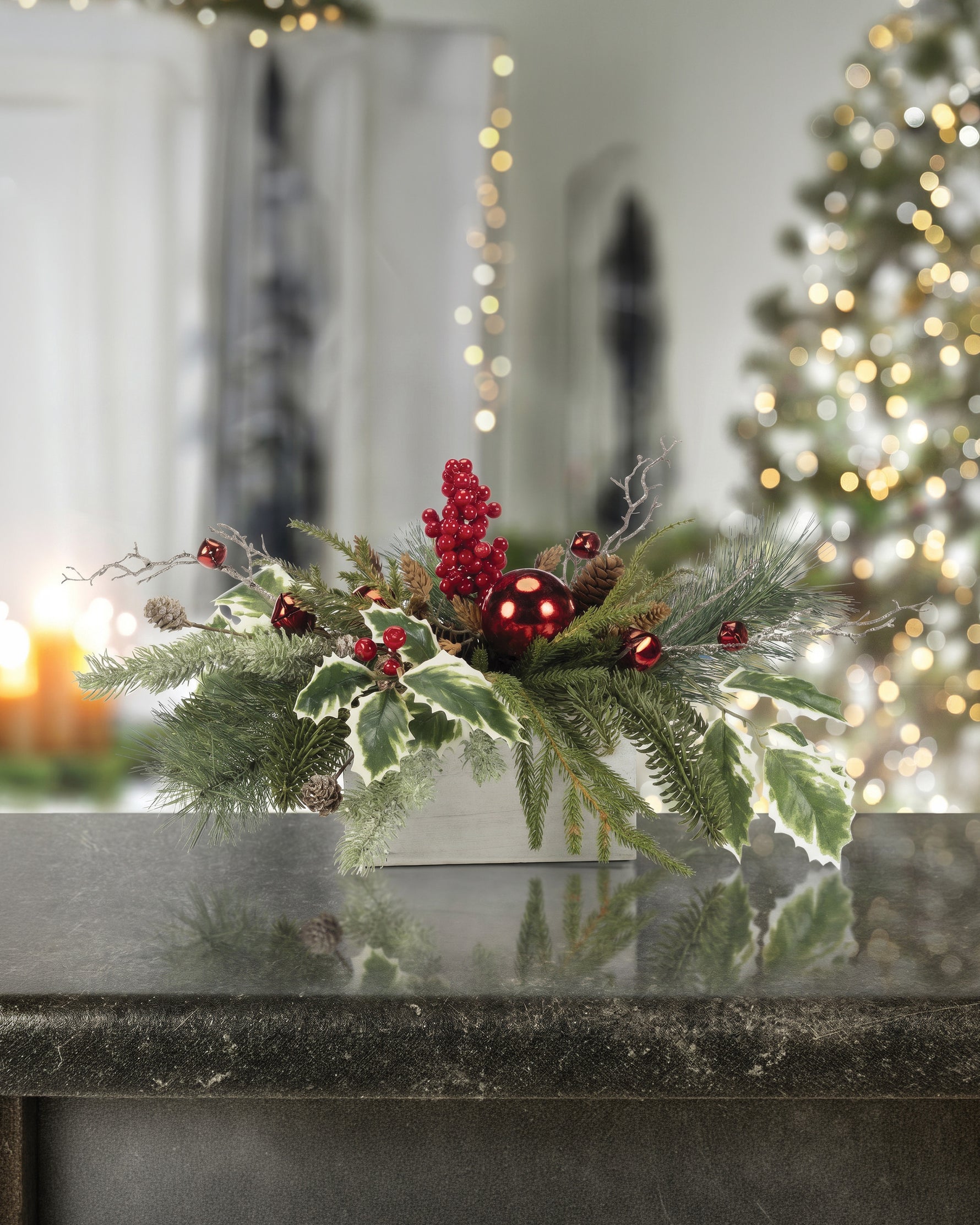 Medium Jingle Bells Artificial Holiday Centerpiece, set in Wood Box Container and christmas decorations surrounding.