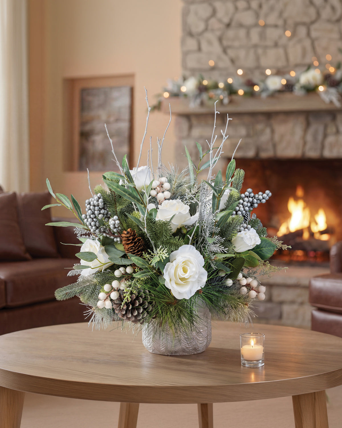 Winter White & Silver Artificial Holiday Centerpiece, set in Tree Embossed Pot, in front of a fireplace.