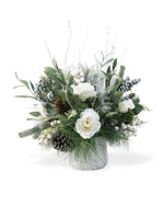 Winter White & Silver Artificial Holiday Centerpiece, set in Tree Embossed Pot, in front of a fireplace.