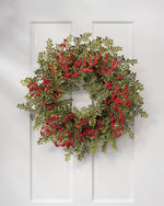 24" Ruscus & Berry Faux Christmas Wreath, hanging on a white wooen door.